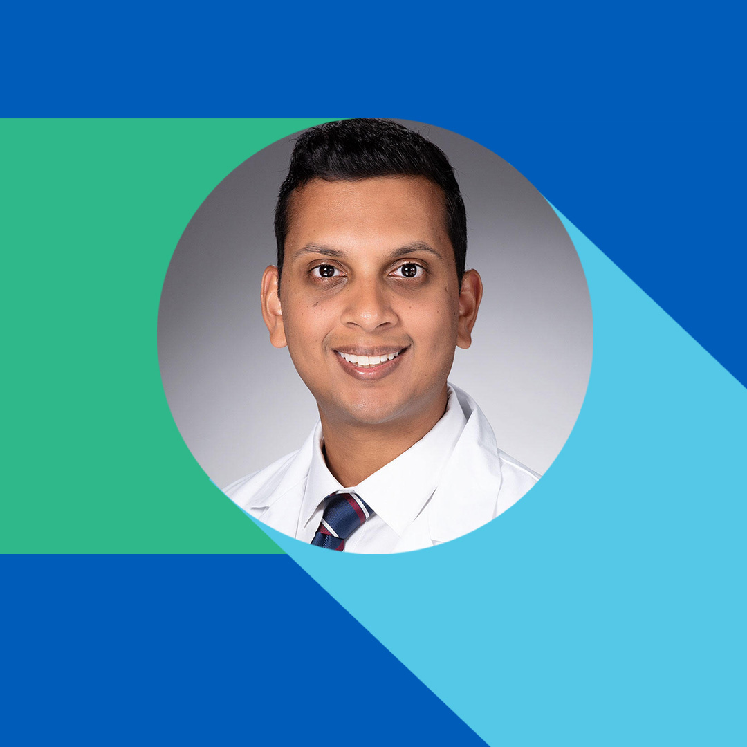Smiling man in white lab coat and tie, on a colorful geometric background